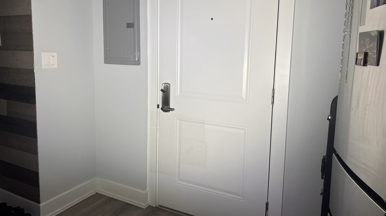 Interior front door lit up by flashlight beam