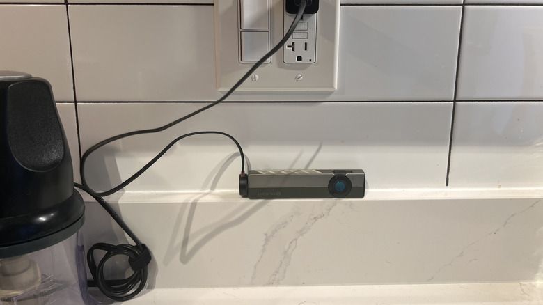 Olight ArkPro charging on a kitchen counter
