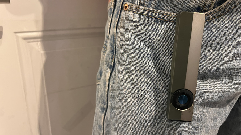 Olight ArkPro flashlight clipped to light denim pants