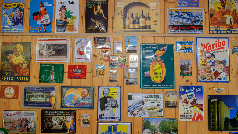 wall filled with vintage tin beer signs