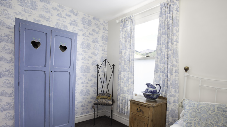 Bedroom with toile curtains and wallpaper