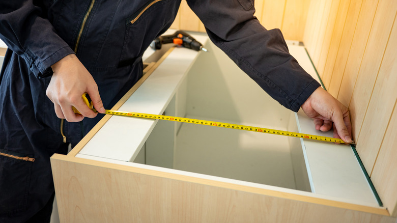 Workman measuring countertop