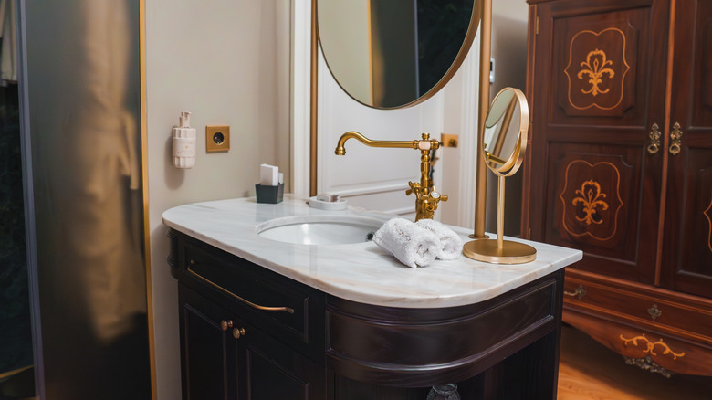 Wooden vanity unit with stone countertop