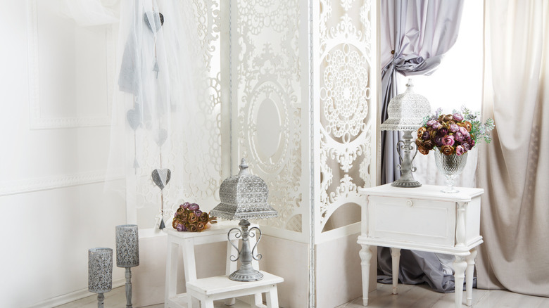 Vintage white painted screen paired with silver antique décor