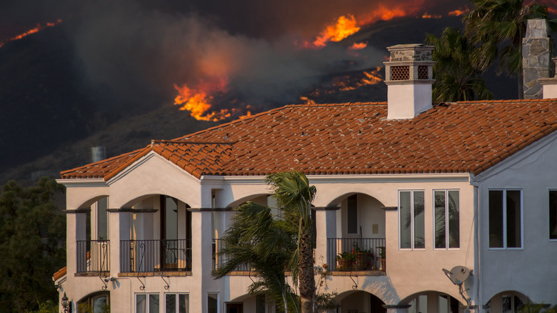 unburned house amid scorched hillsides