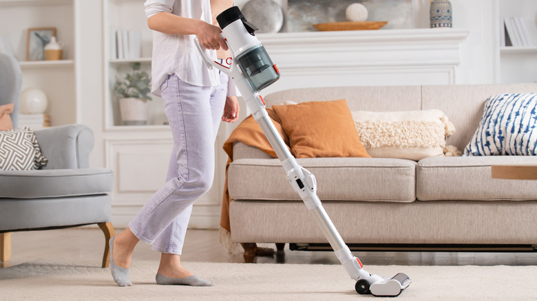 woman using a cordless vacuum 