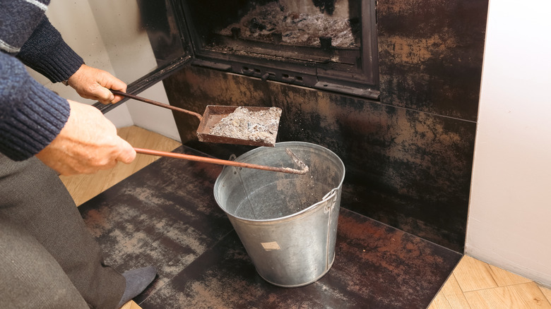 Man removing ash from the fireplace