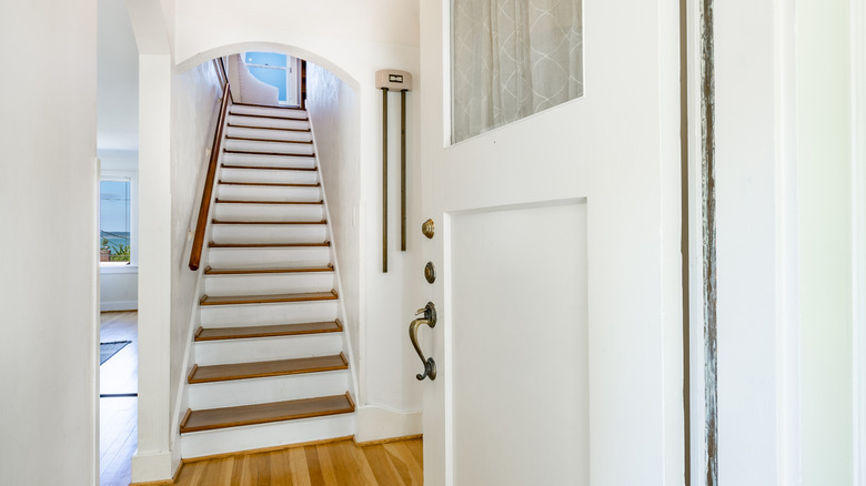 A midcentury painted staircase with wooden treads