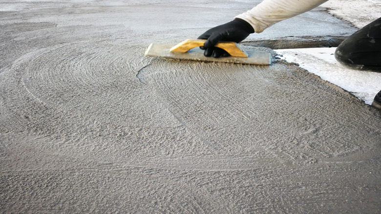 Person using a float on wet concrete