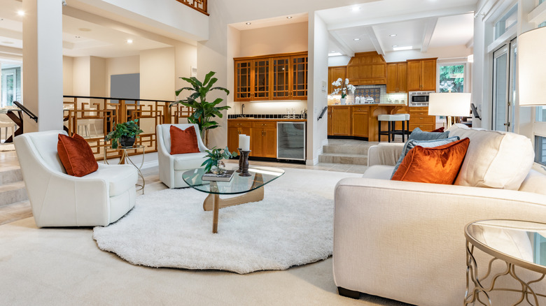 Modern open layout home. Living room, dining room, kitchen, and etnertainment room sharing one large space separated by stairs and columns