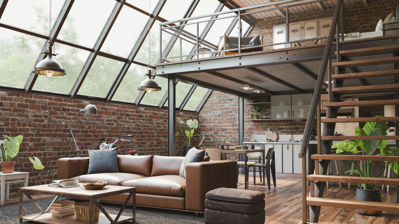 Loft condo with open concept layout; bedroom on the upper level, living room, kitchen, and dining room on the lower level.