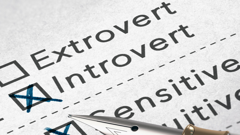 The words "extrovert" and "introvert" on a paper with a box checked next to introvert