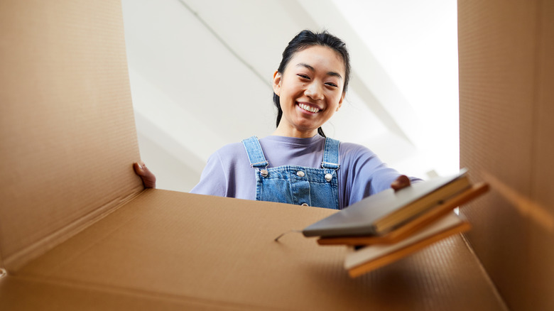 woman putting books in box