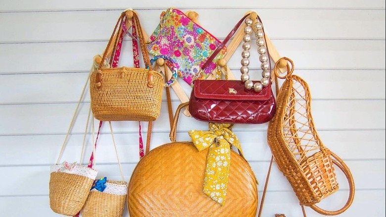 A series of handbags hung on an accordion rack