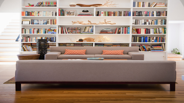 bookshelf with neatly organized board games in book boxes