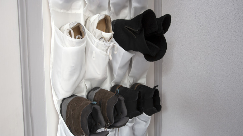 A fabric over-the-door organizer with shoes stored inside