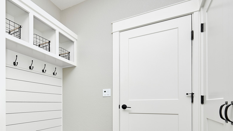 An entryway with hooks and shelves