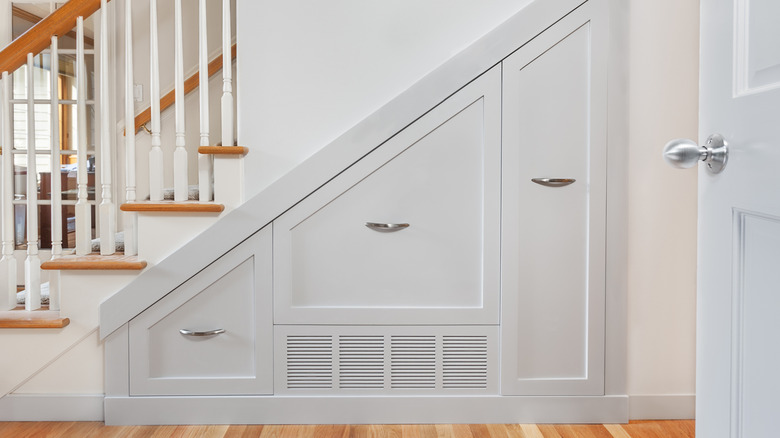 A stairway with custom pull-out drawers built into the space beneath the stairs