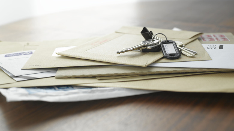 A pile of mail with keys on top