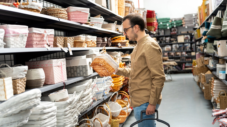 Man shopping for storage baskets in a home goods store