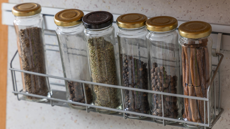 Bottles of spice in a metal rack