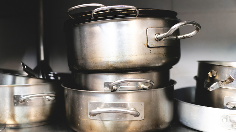 Pots and pans stacked on a shelf