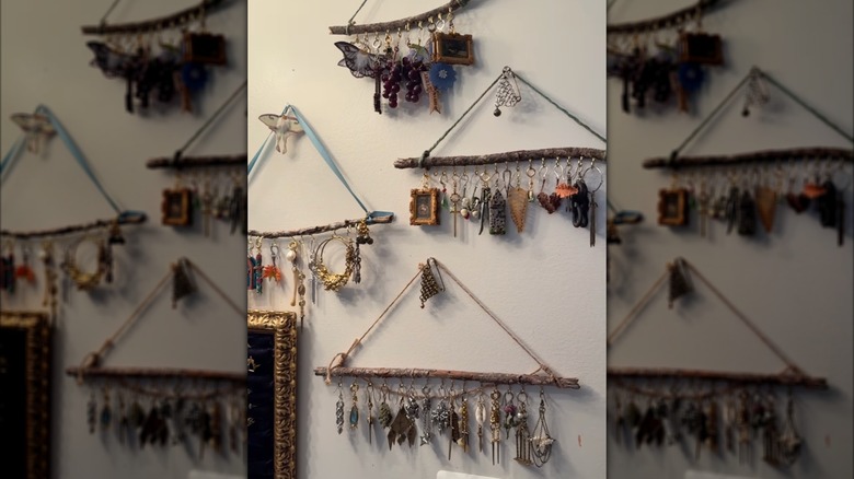 Finished DIY rustic jewelry organizers made with a stick hang on the wall.