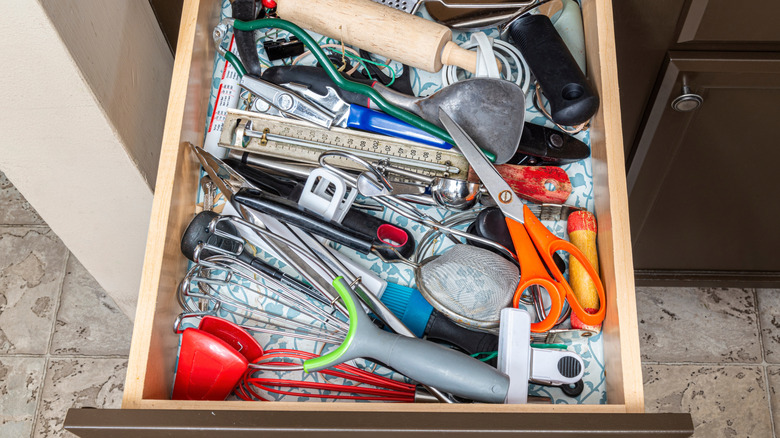 Messy utensil drawer with duplicate items