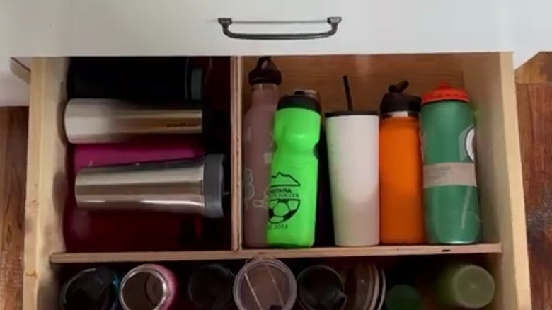 Variety of water bottles laying flat in a drawer
