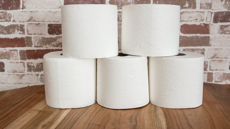 White toilet paper rolls on wood table