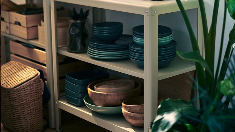 KOLBJÖRN shelf unit holding a variety of items, including dishes