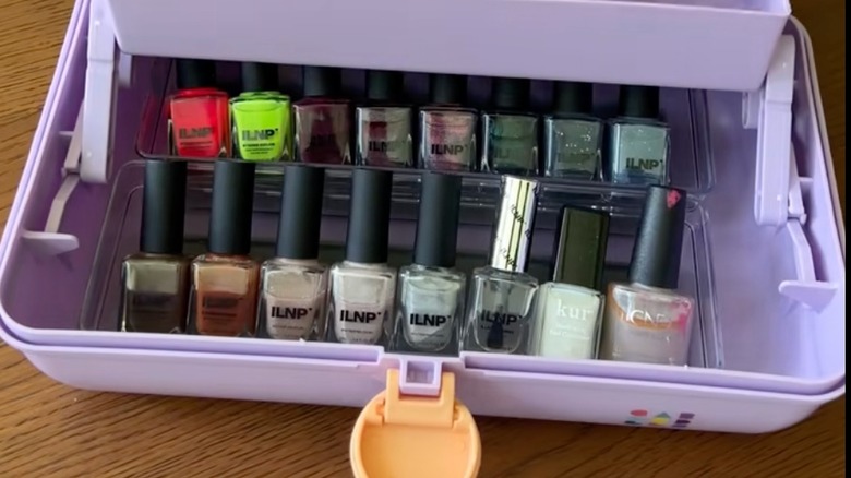 A purple Caboodle with nail polish inside.