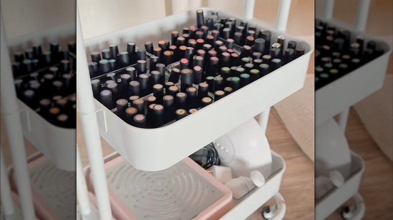 Closeup of a rolling cart with nail polish filing a tier