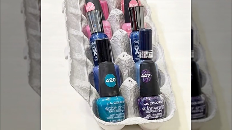 An upcycled egg carton with nail polish bottles in each cup.