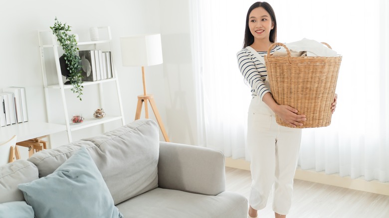 person carrying laundry basket