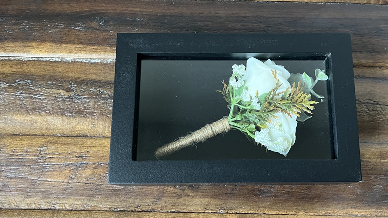 black shadow box with boutonniere