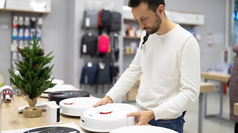 man shopping for robot vaccum