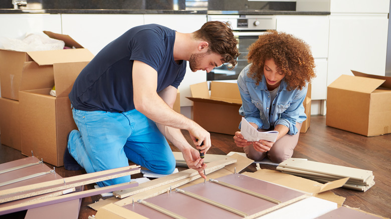 People assembling furniture