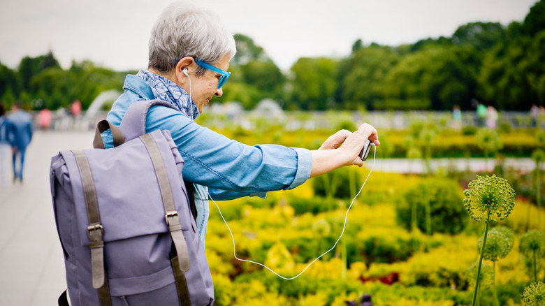 woman taking photo at garden