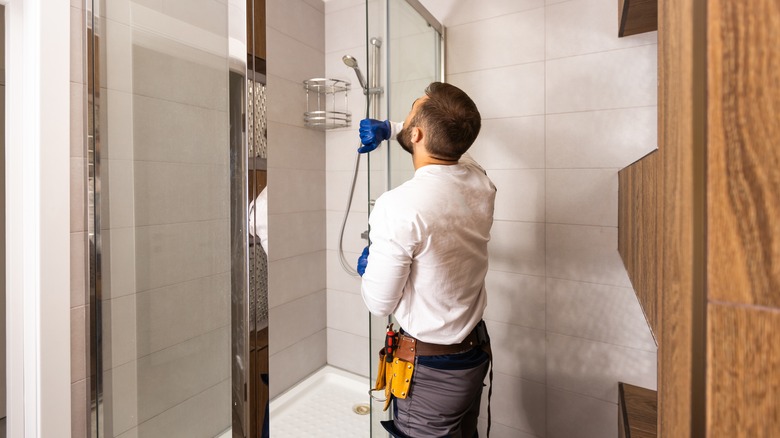 man replacing shower