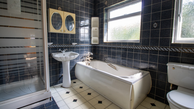 vintage style bathroom with black tiles