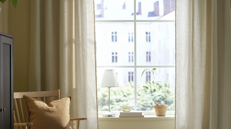Cream colored IKEA DYTÅG curtains framing a large window