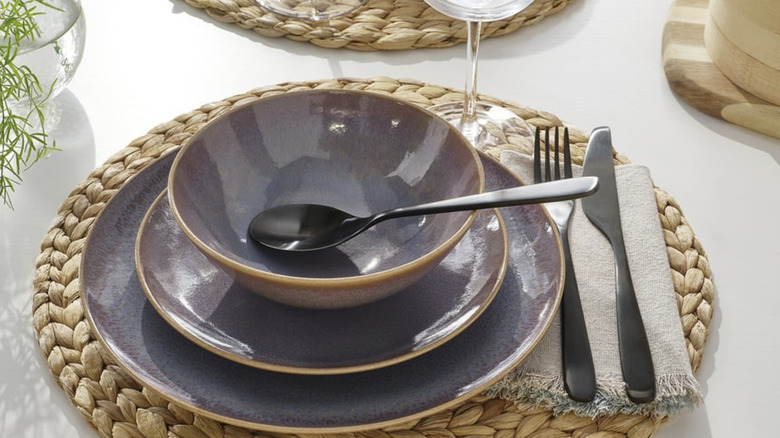 Purple IKEA FÄRGKLAR dishes on a woven placemat