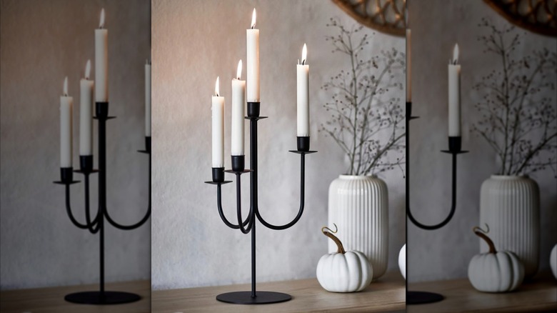 A black HÖSTAGILLE candelabra with white candles