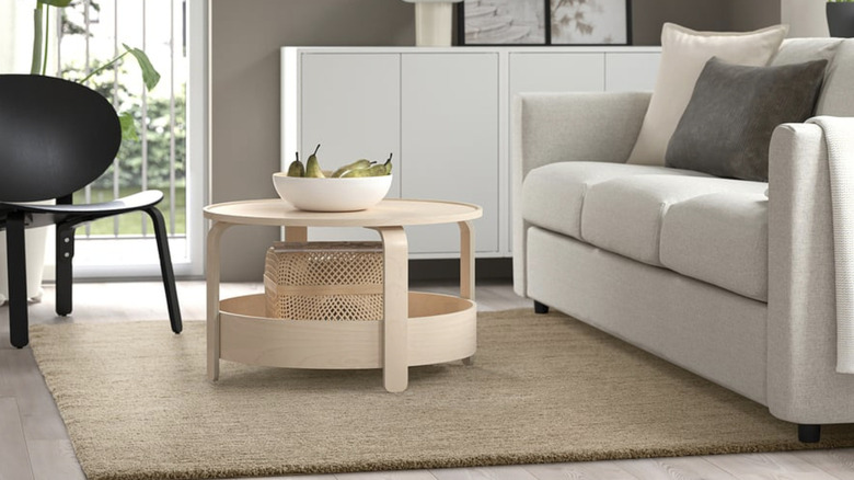 A woven IKEA STOENSE rug in a living room