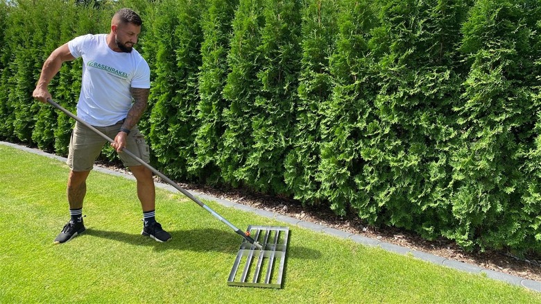 Man using Rasenrakel leveling rake