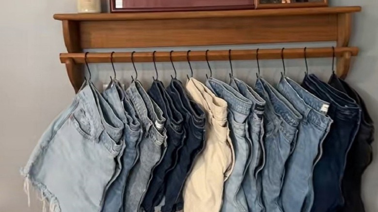 Thrifted wall shelf turned into extra storage solution for hanging clothes