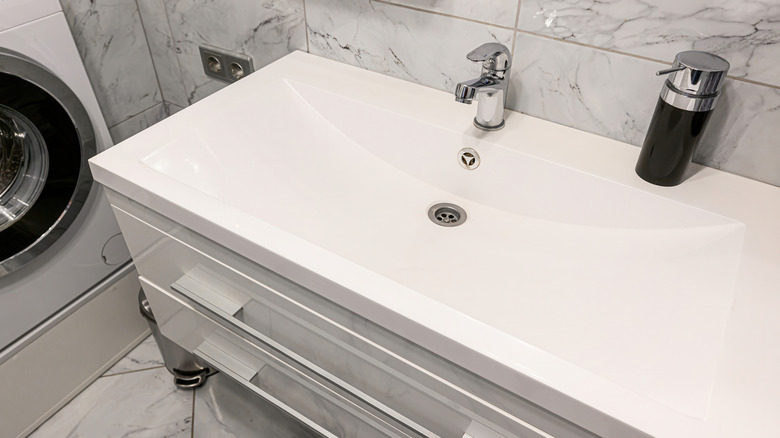 Modern white bathroom sink with chrome faucet