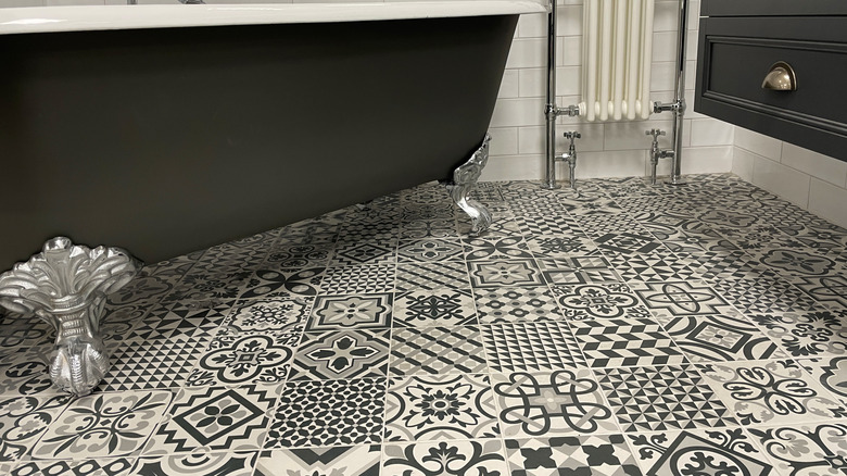 Bathroom with busy black and white floor tiling