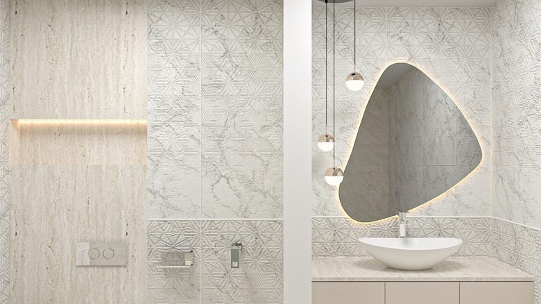 White bathroom with asymmetrical mirror